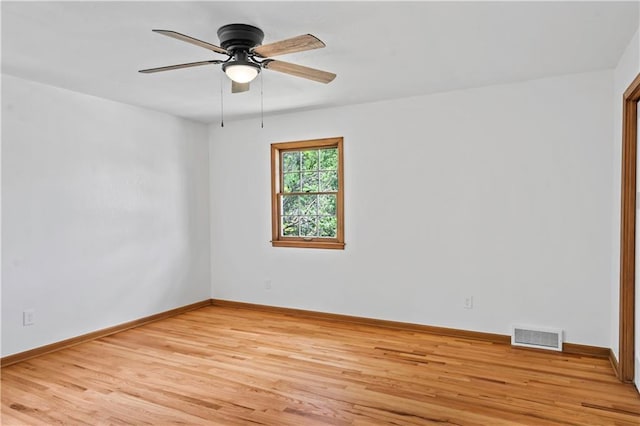 4417 E 104th St, Kansas City, MO 64137 - spare room featuring light wood-style floors, a ceiling fan, and baseboards