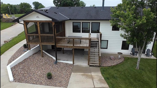 566 Lake Viking Ter, Gallatin, MO 64640 - view of front of property with a sunroom, roof with shingles, stairs, a patio area, and a front yard
