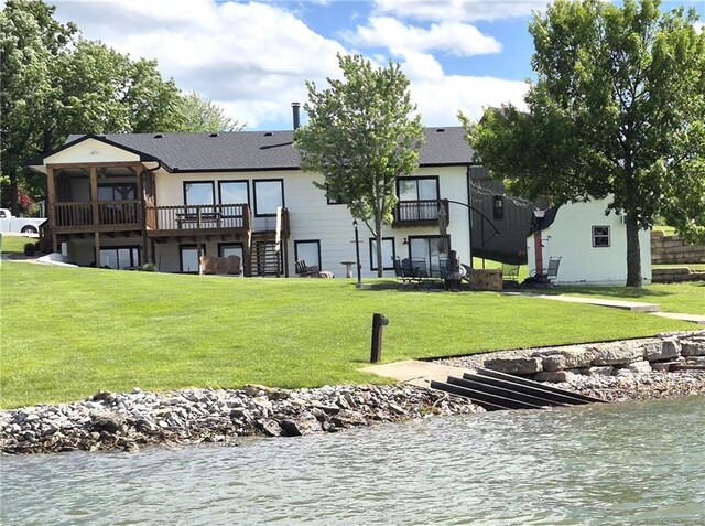 566 Lake Viking Ter, Gallatin, MO 64640 - back of house with a yard, stairs, a sunroom, a deck with water view, and roof with shingles