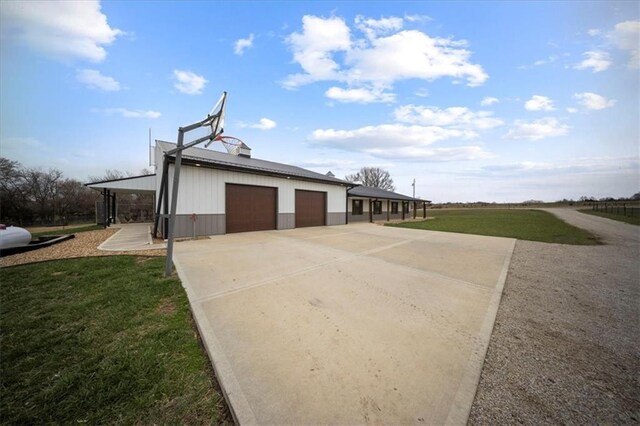 690 SW T Hwy, Holden, MO 64040 - view of home's exterior featuring concrete driveway and a yard