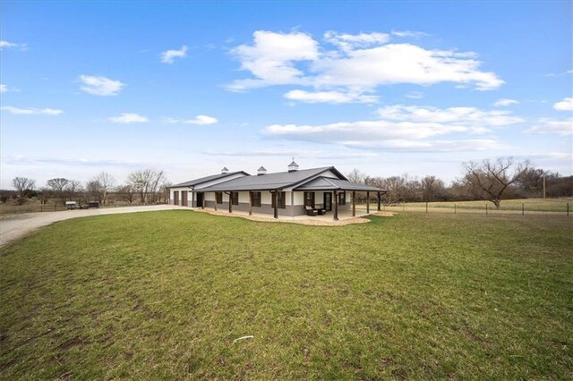 690 SW T Hwy, Holden, MO 64040 - view of front of house with driveway, a patio area, and a garage