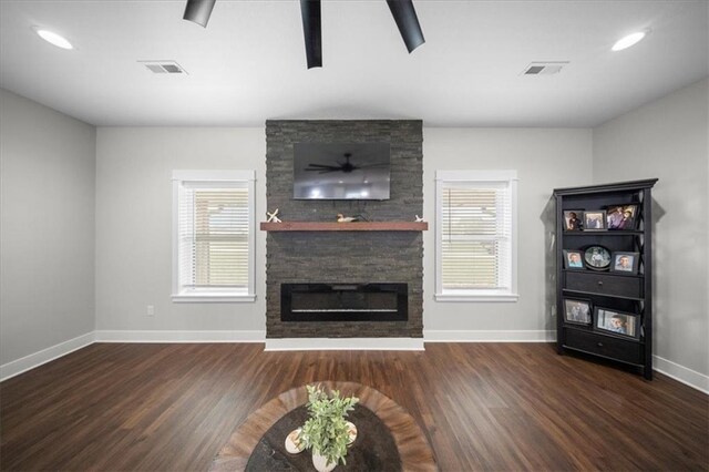 690 SW T Hwy, Holden, MO 64040 - living room featuring baseboards, wood finished floors, and a fireplace