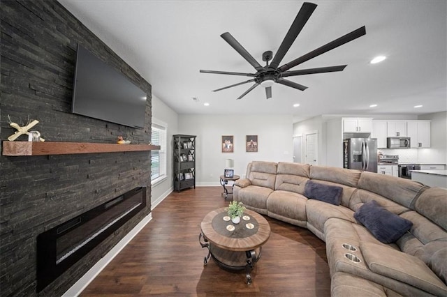 690 SW T Hwy, Holden, MO 64040 - living area featuring a fireplace, ceiling fan, dark wood-type flooring, baseboards, and recessed lighting