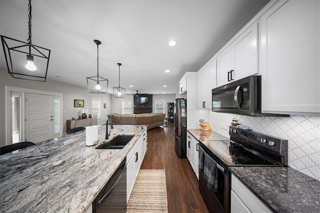 690 SW T Hwy, Holden, MO 64040 - kitchen with black appliances, a sink, open floor plan, dark wood-type flooring, and white cabinets