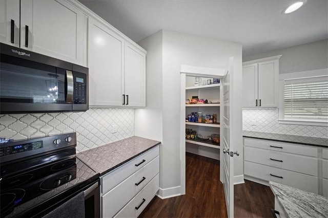 690 SW T Hwy, Holden, MO 64040 - kitchen featuring black range with electric cooktop, dark wood-style flooring, white cabinetry, backsplash, and recessed lighting