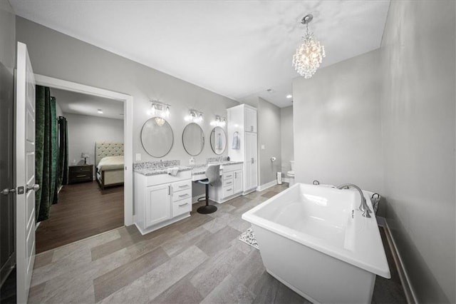 690 SW T Hwy, Holden, MO 64040 - bathroom with a freestanding bath, vanity, ensuite bath, and a chandelier