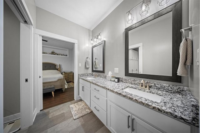 690 SW T Hwy, Holden, MO 64040 - ensuite bathroom with double vanity and wood finished floors