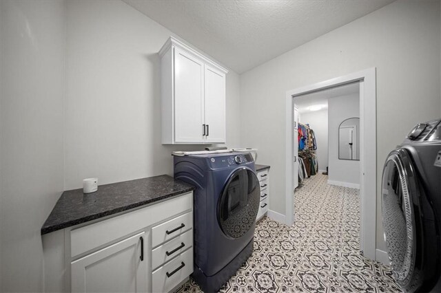 690 SW T Hwy, Holden, MO 64040 - laundry area with separate washer and dryer, cabinet space, a textured ceiling, and baseboards