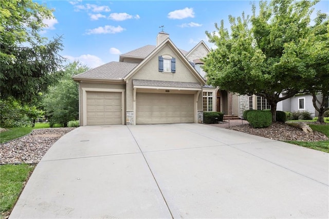 9300 W 156th Pl, Overland Park, KS 66221 - traditional home with driveway, stone siding, a garage, stucco siding, and a chimney