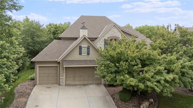 9300 W 156th Pl, Overland Park, KS 66221 - view of front of property featuring stone siding, driveway, stucco siding, and a shingled roof
