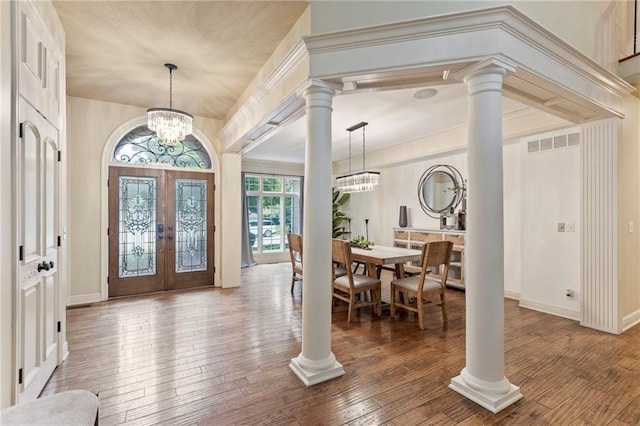 9300 W 156th Pl, Overland Park, KS 66221 - entrance foyer featuring french doors, ornate columns, a chandelier, and hardwood / wood-style flooring