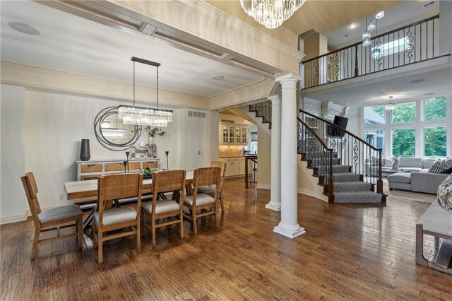 9300 W 156th Pl, Overland Park, KS 66221 - dining room with a chandelier, stairs, crown molding, wood finished floors, and ornate columns