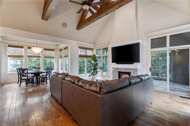 9300 W 156th Pl, Overland Park, KS 66221 - living room featuring high vaulted ceiling, a fireplace, a ceiling fan, beam ceiling, and wood-type flooring