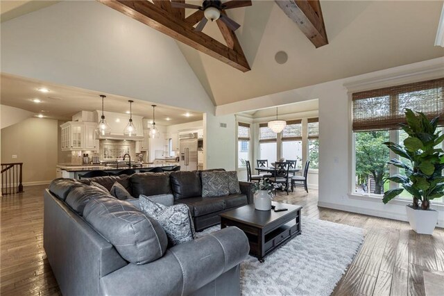 9300 W 156th Pl, Overland Park, KS 66221 - living area with a ceiling fan, baseboards, beam ceiling, high vaulted ceiling, and wood finished floors