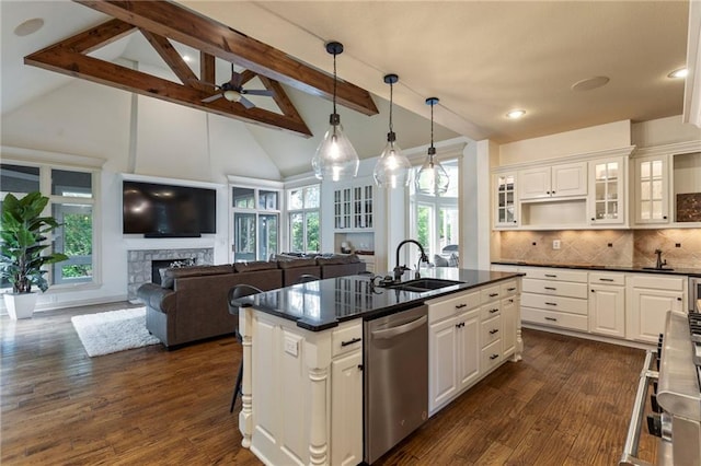 9300 W 156th Pl, Overland Park, KS 66221 - kitchen with dishwasher, a sink, dark countertops, beamed ceiling, and a fireplace