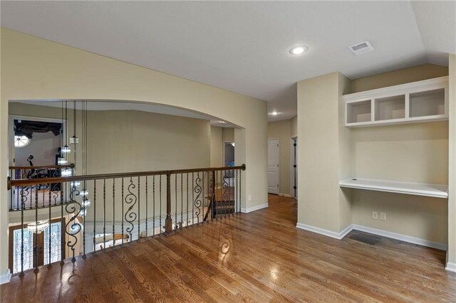 9300 W 156th Pl, Overland Park, KS 66221 - hallway featuring wood finished floors, baseboards, arched walkways, and recessed lighting