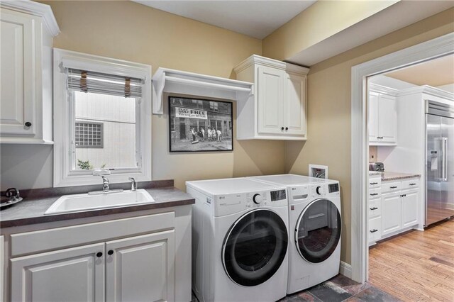 9300 W 156th Pl, Overland Park, KS 66221 - laundry area featuring cabinet space, independent washer and dryer, and light wood-type flooring