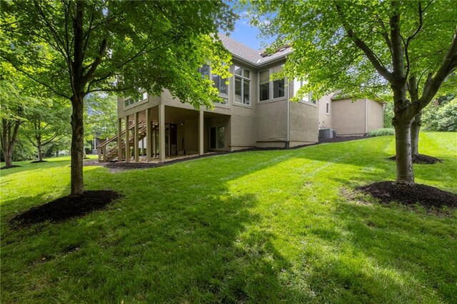 9300 W 156th Pl, Overland Park, KS 66221 - view of grassy yard featuring stairway and central AC unit