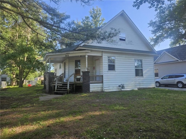 303 W Park St, Pittsburg, KS 66762 - view of side of home featuring covered porch and a lawn
