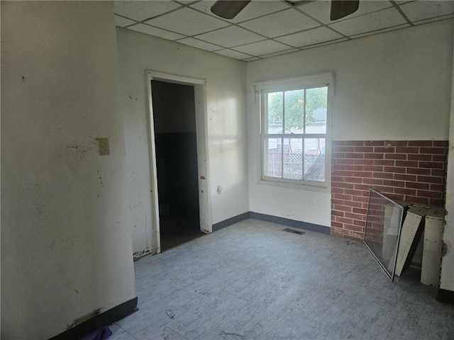 303 W Park St, Pittsburg, KS 66762 - empty room with a paneled ceiling, a ceiling fan, and wood finished floors