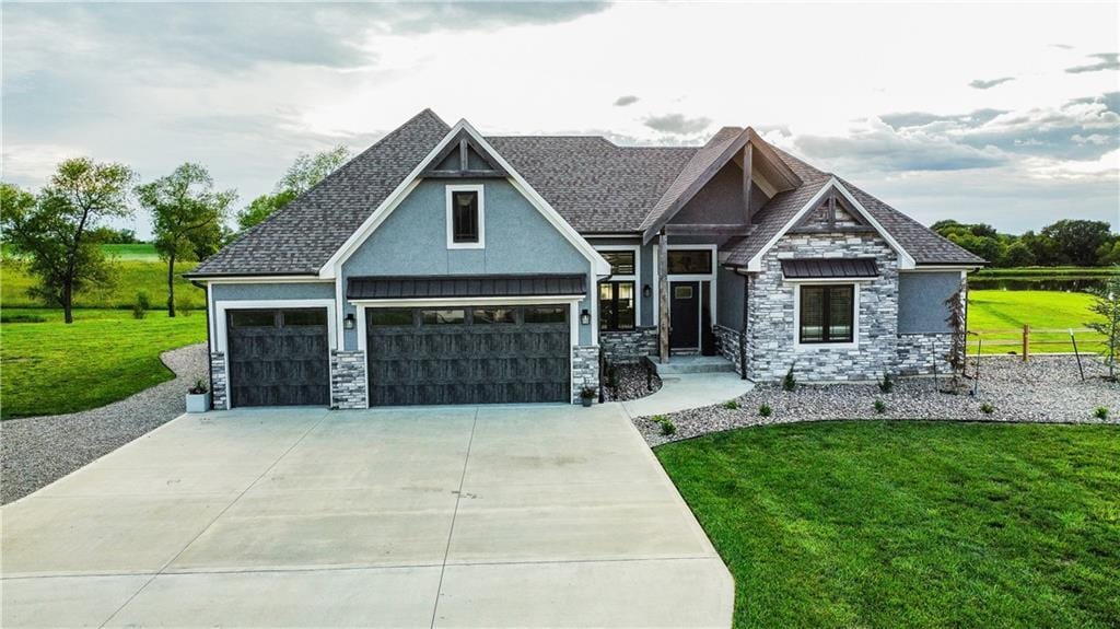 6640 Tucker Dr, Odessa, MO 64076 - craftsman inspired home featuring stone siding, concrete driveway, stucco siding, and an attached garage