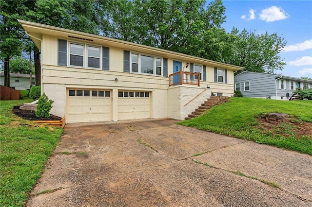 3218 NE 47th St, Kansas City, MO 64119 - ranch-style home with a front lawn, stairway, concrete driveway, and a garage