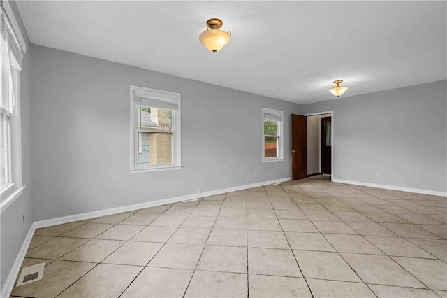 3218 NE 47th St, Kansas City, MO 64119 - unfurnished room featuring baseboards and light tile patterned floors