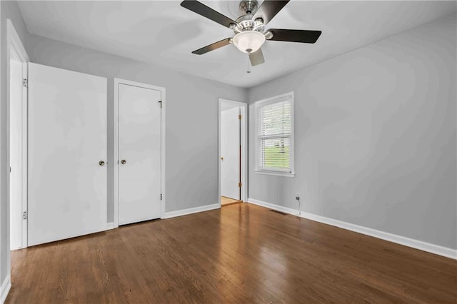 3218 NE 47th St, Kansas City, MO 64119 - unfurnished bedroom with wood finished floors, baseboards, and ceiling fan