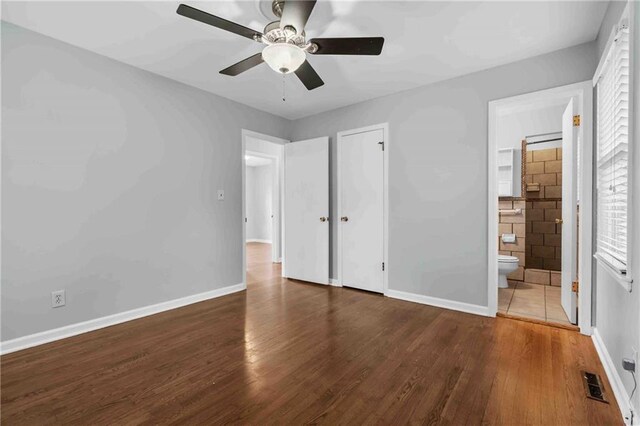 3218 NE 47th St, Kansas City, MO 64119 - unfurnished bedroom featuring wood finished floors, baseboards, and ensuite bath