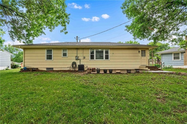3218 NE 47th St, Kansas City, MO 64119 - rear view of property with a lawn and central air condition unit