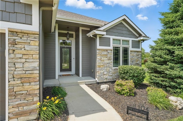 1104 NW 109th St, Kansas City, MO 64155 - doorway to property featuring stone siding and roof with shingles