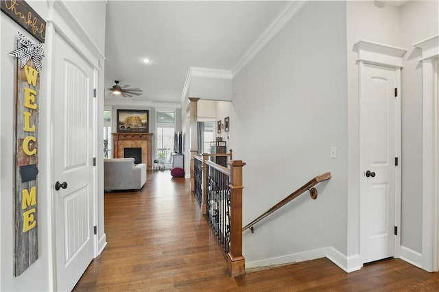 1104 NW 109th St, Kansas City, MO 64155 - corridor with an upstairs landing, dark wood-style flooring, crown molding, baseboards, and recessed lighting