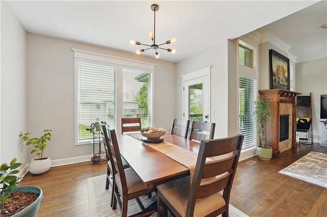 1104 NW 109th St, Kansas City, MO 64155 - dining room with a chandelier, hardwood / wood-style flooring, baseboards, and a high end fireplace
