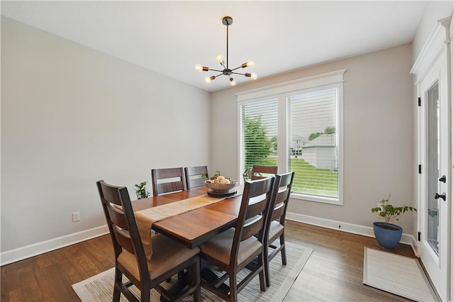 1104 NW 109th St, Kansas City, MO 64155 - dining area featuring baseboards, a chandelier, and wood finished floors
