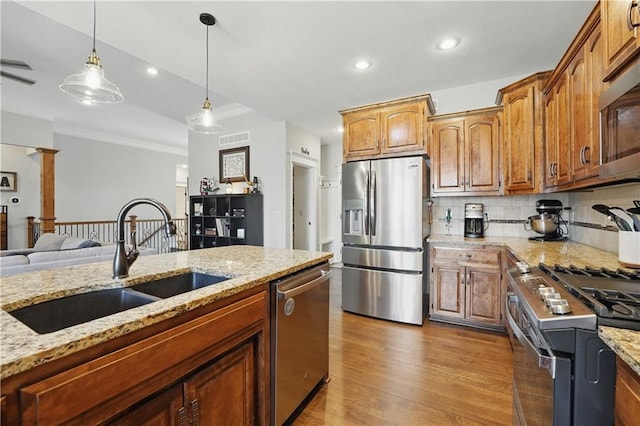 1104 NW 109th St, Kansas City, MO 64155 - kitchen with appliances with stainless steel finishes, a sink, pendant lighting, decorative backsplash, and ornamental molding