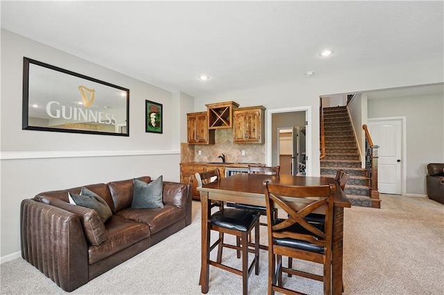 1104 NW 109th St, Kansas City, MO 64155 - dining room featuring light colored carpet, stairs, recessed lighting, and baseboards