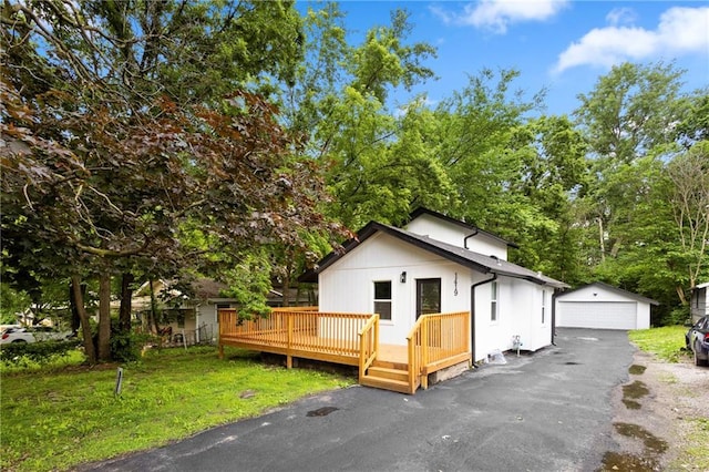 1419 Washington Blvd, Kansas City, KS 66102 - view of front of house with a detached garage, a deck, an outdoor structure, and a front yard
