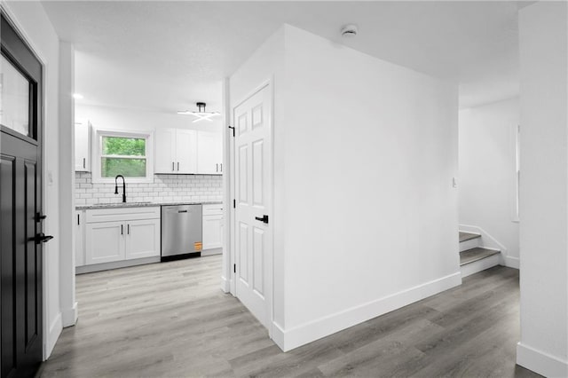 1419 Washington Blvd, Kansas City, KS 66102 - corridor with a sink, light wood-style floors, stairs, and baseboards