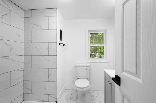 1419 Washington Blvd, Kansas City, KS 66102 - bathroom featuring vanity, baseboards, marble finish floors, and toilet