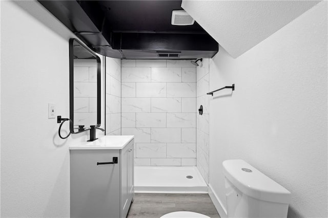 1419 Washington Blvd, Kansas City, KS 66102 - full bath featuring toilet, vanity, a shower stall, and wood finished floors