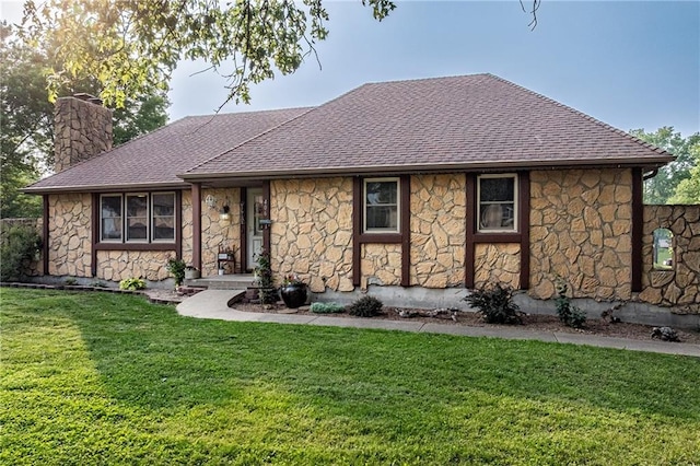 406 Frederick Dr, Gower, MO 64454 - view of front of house featuring stone siding, a chimney, roof with shingles, and a front yard