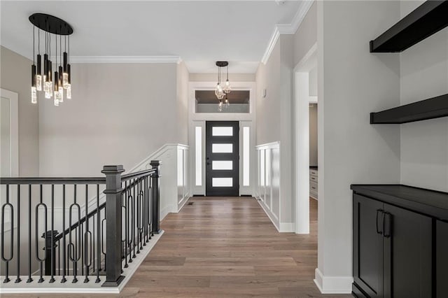 14278 S Houston St, Olathe, KS 66061 - entrance foyer featuring a chandelier, wood finished floors, crown molding, and baseboards