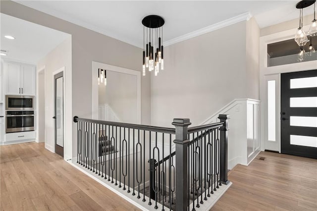 14278 S Houston St, Olathe, KS 66061 - entrance foyer with a chandelier, light wood-style flooring, and ornamental molding