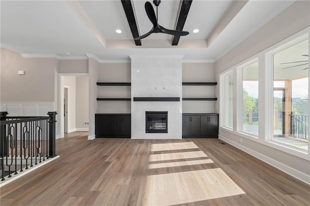 14278 S Houston St, Olathe, KS 66061 - unfurnished living room with ceiling fan, wood finished floors, a tiled fireplace, recessed lighting, and a raised ceiling