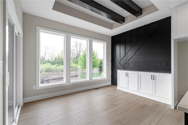 14278 S Houston St, Olathe, KS 66061 - spare room featuring baseboards, light wood-style floors, and a raised ceiling