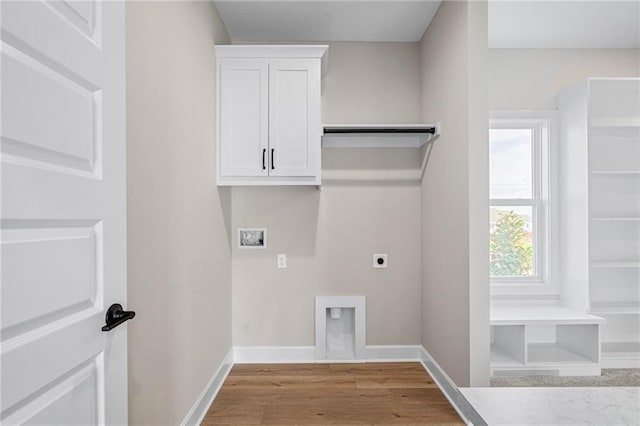 14278 S Houston St, Olathe, KS 66061 - laundry room with electric dryer hookup, washer hookup, light wood-style flooring, baseboards, and cabinet space