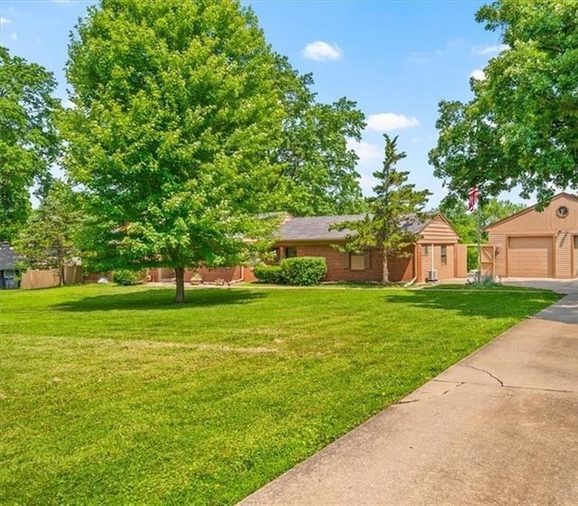 2306 Red Bridge Ter, Kansas City, MO 64131 - view of yard featuring a garage and an outdoor structure