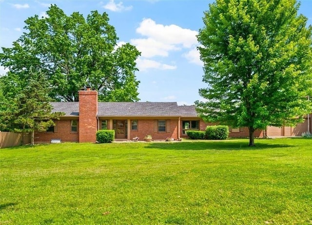 2306 Red Bridge Ter, Kansas City, MO 64131 - back of property with brick siding and a chimney