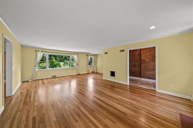 2306 Red Bridge Ter, Kansas City, MO 64131 - unfurnished living room featuring crown molding, baseboards, wood finished floors, and recessed lighting