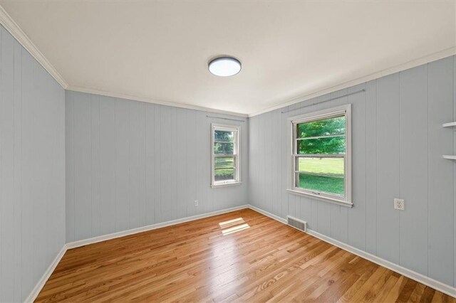 2306 Red Bridge Ter, Kansas City, MO 64131 - unfurnished room with wood finished floors, baseboards, and ornamental molding